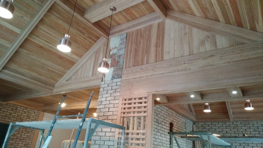 Loft lined in timber with the original brick gable left exposed