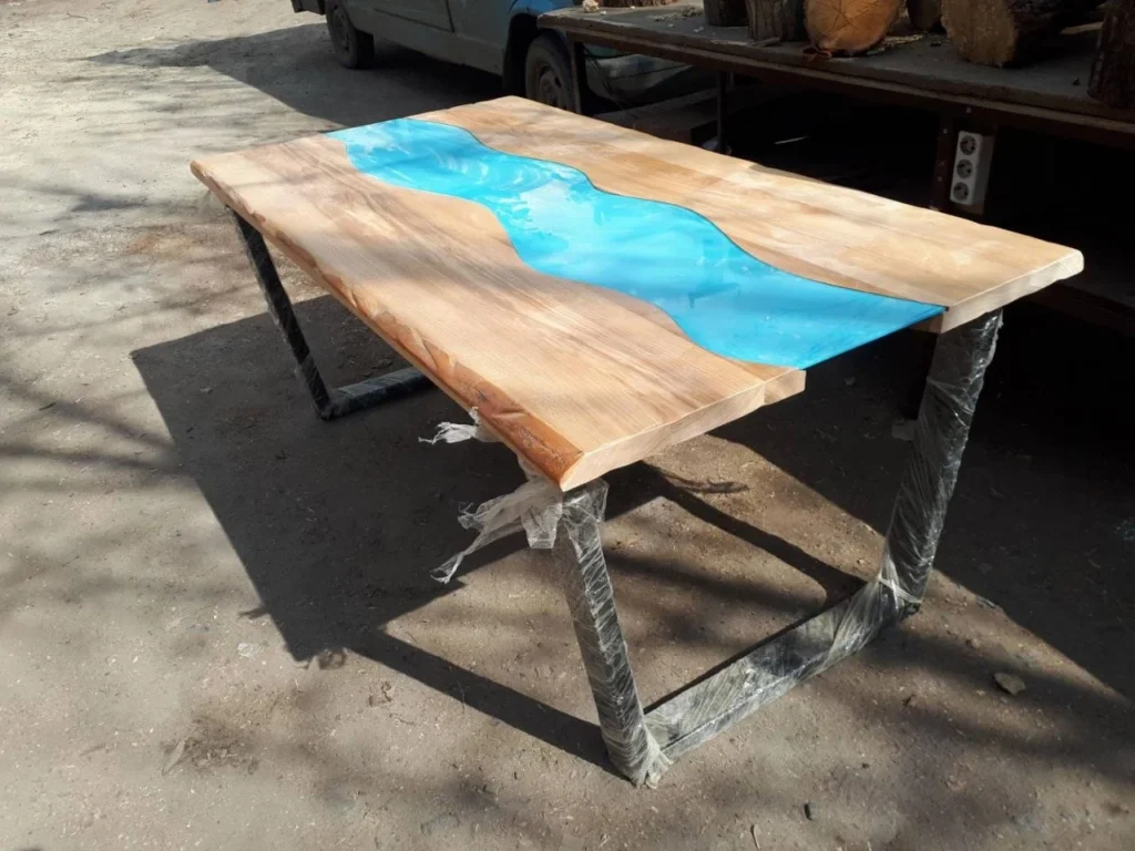 Live edge timber table with a blue resin river down the centre