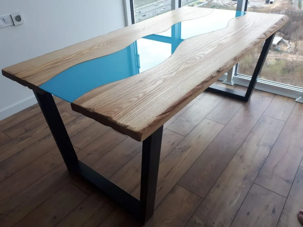Live edge timber table with a resin inlay on a welded steel frame