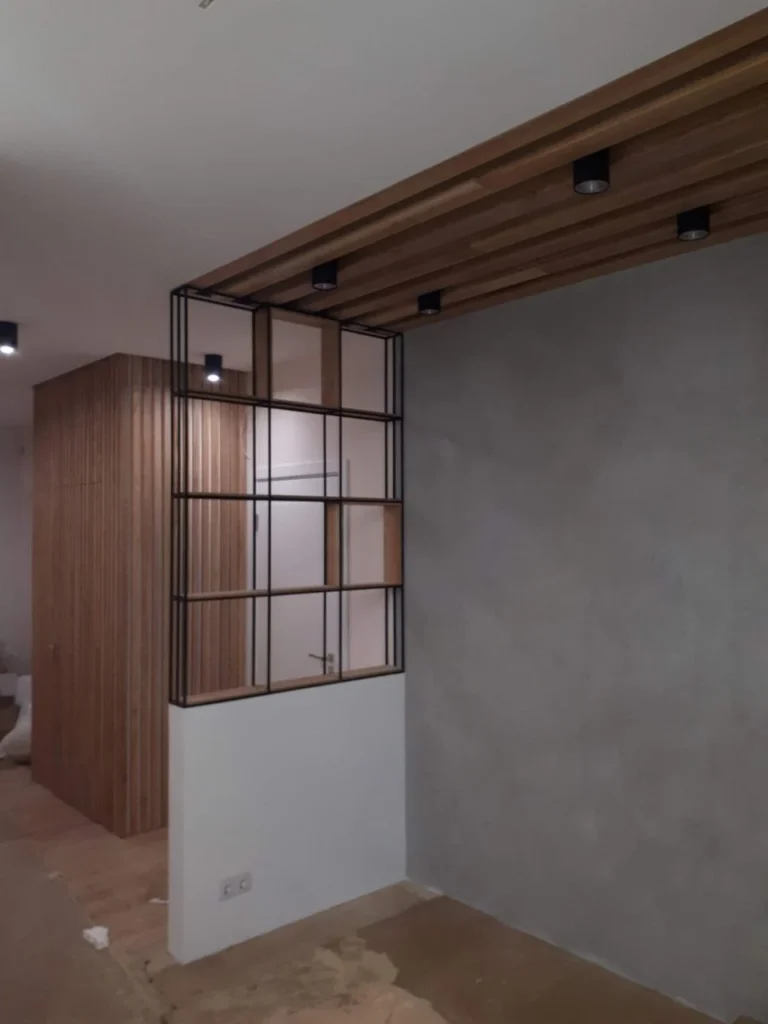 Black steel frame against a timber slat ceiling in a finished room