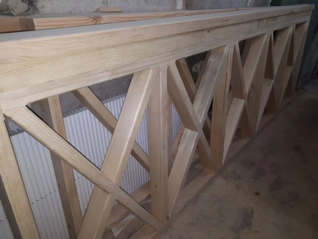 Pale sawn timber studwork braced and standing in a room being rebuilt