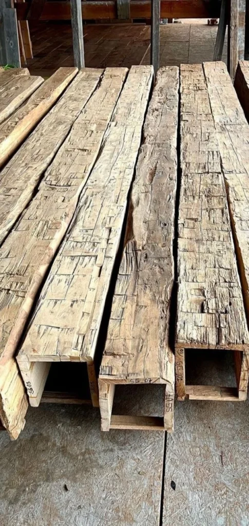 Sawn timber beams stacked in the yard before a frame goes up
